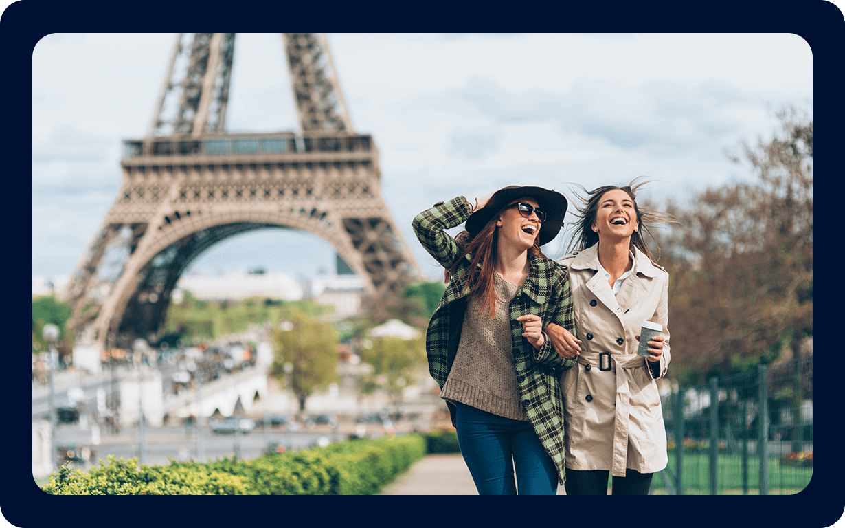 Two people laughing in front of Eiffel Tower in France