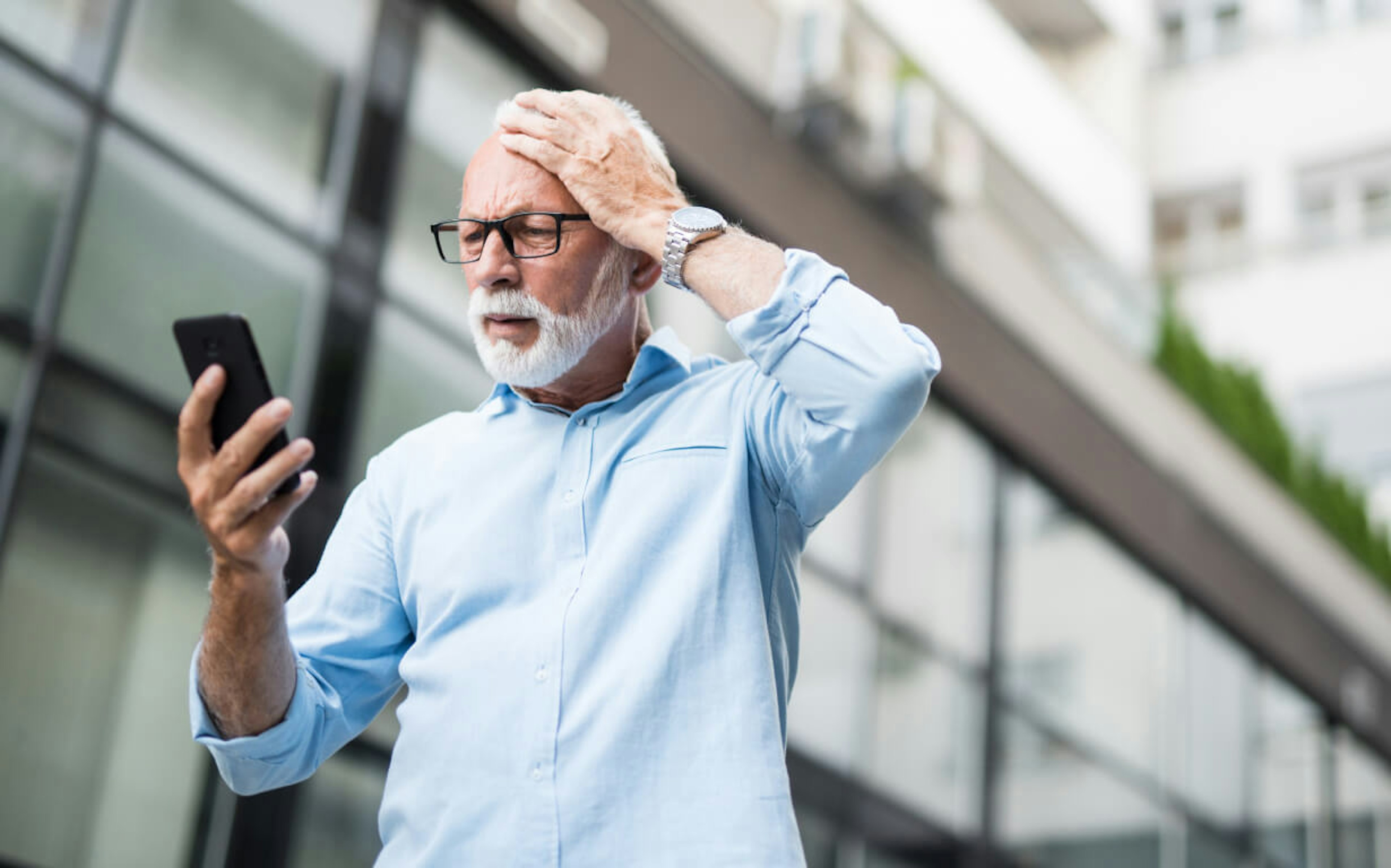 Man looking at his phone in dibelief.