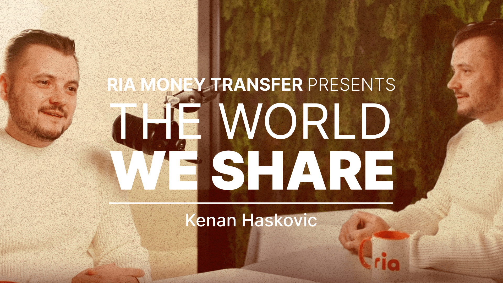 Two people sit at a table with a microphone and an orange mug. Text on the image reads: “RIA Money Transfer presents THE WORLD WE SHARE, Kenan Haskovic.” Green and beige background with plants.